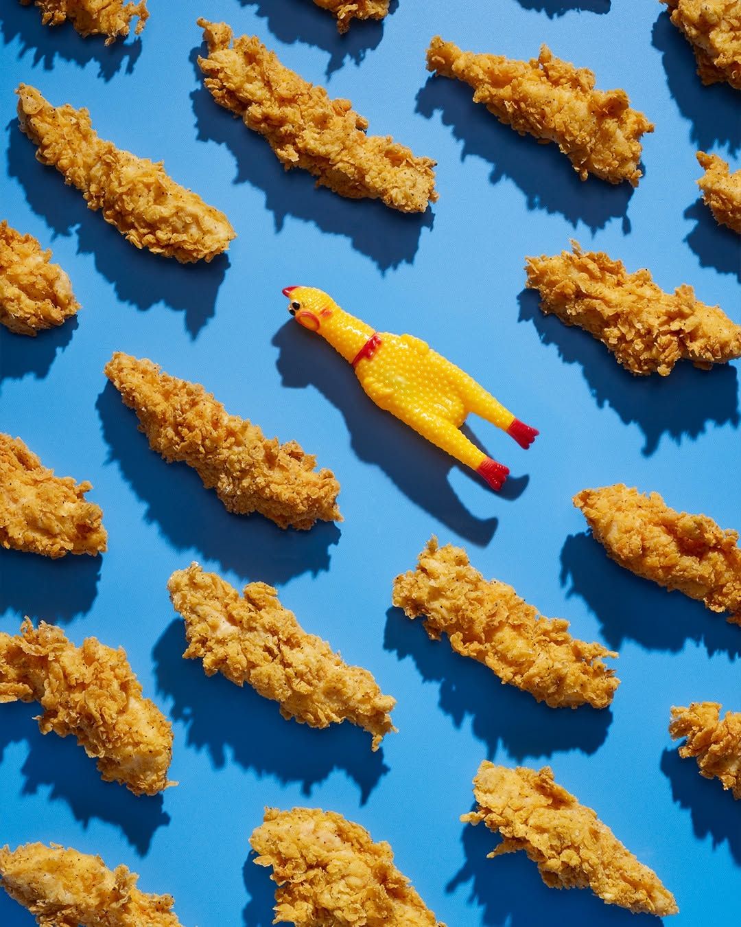Rows of chicken tenders with a rubber chicken hidden among them